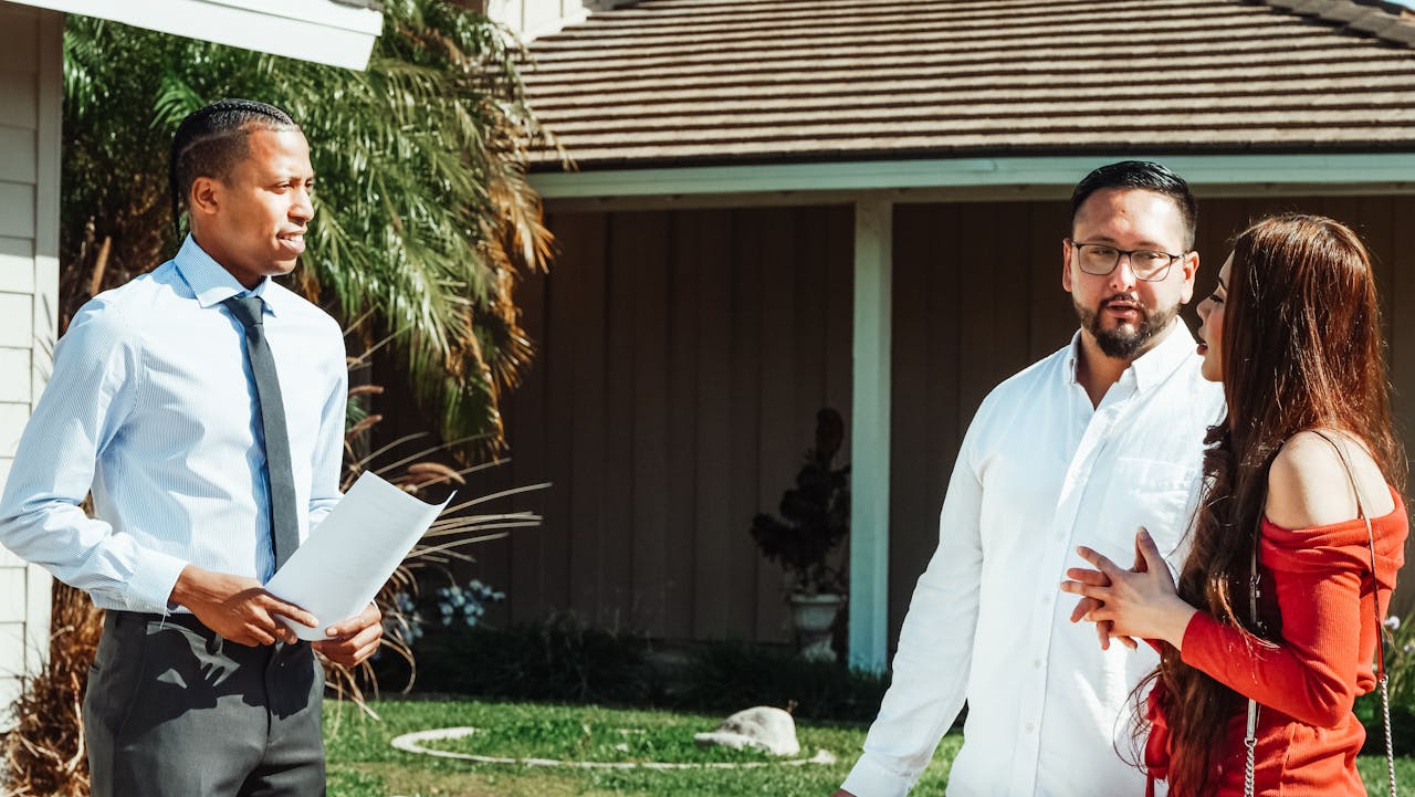 A real estate agent showing a house to a couple, discussing options.