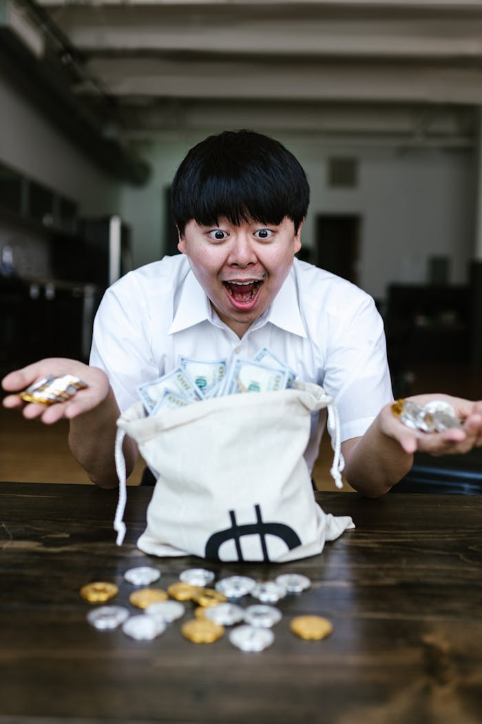 digital Asian man excitedly holding cryptocurrency and US dollars, symbolizing financial success and wealth.